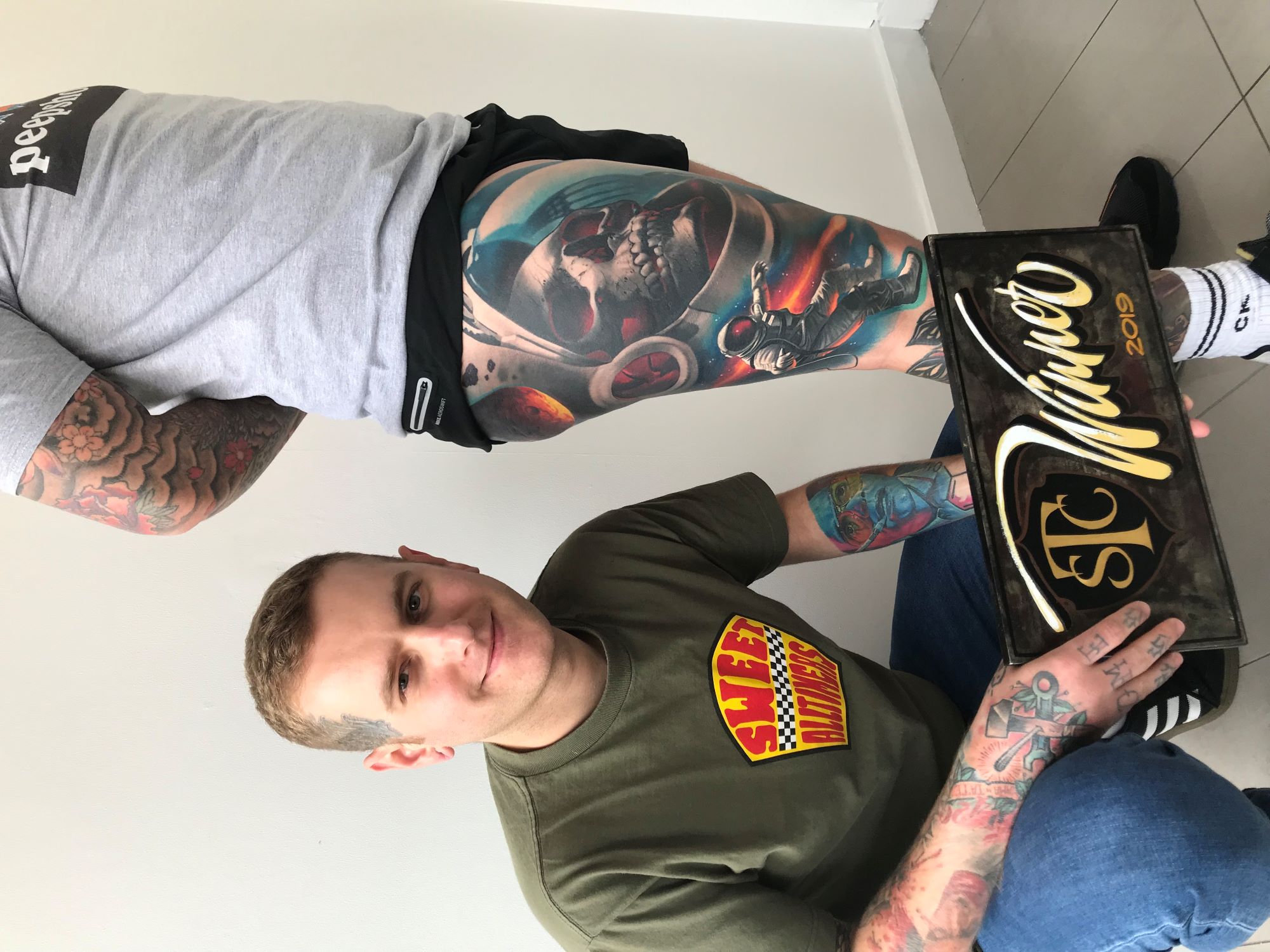 Tattoo artist working on a client
