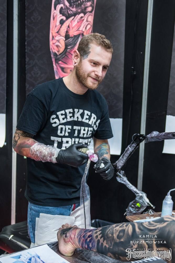Tattoo artist working on a client